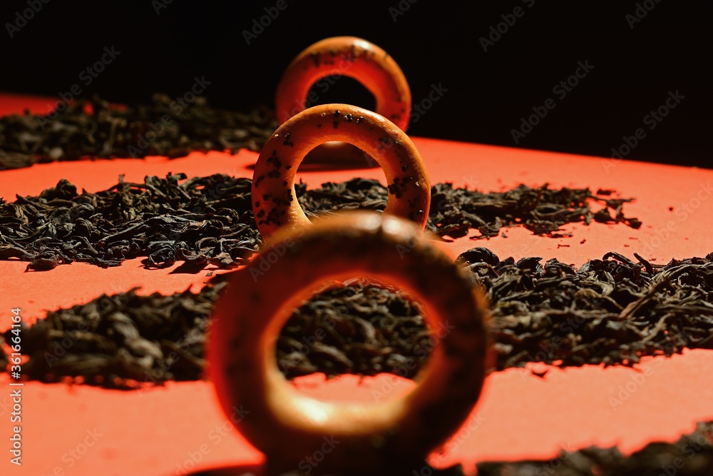 Composition of bagels with poppy seeds and dried leaves of black tea Composition of bagels with poppy seeds and dried leaves of black tea
