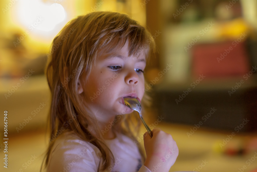 little girl eats alone
