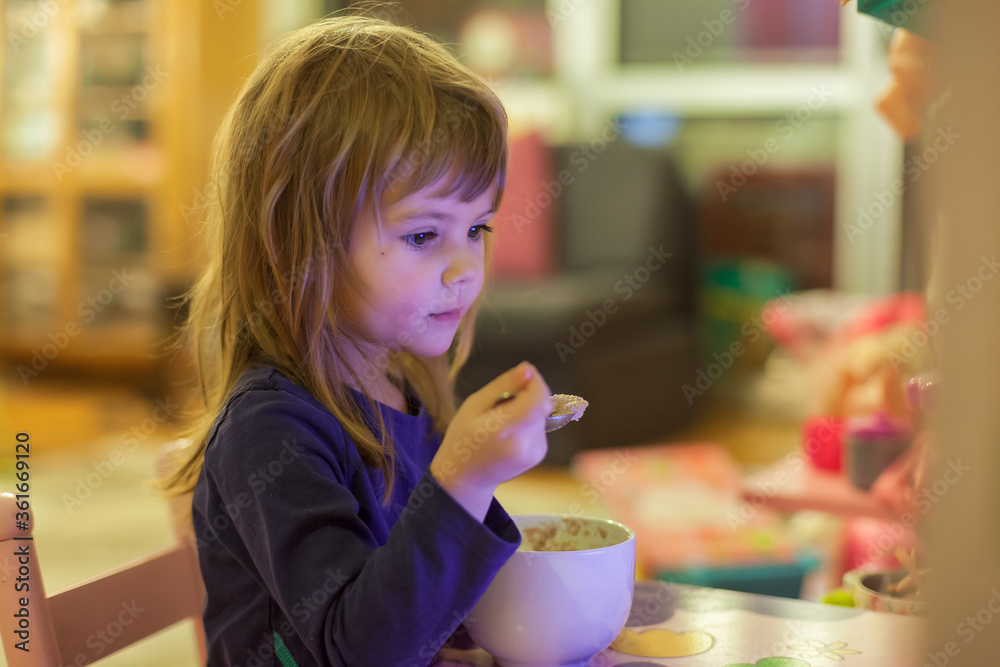 little girl eats alone