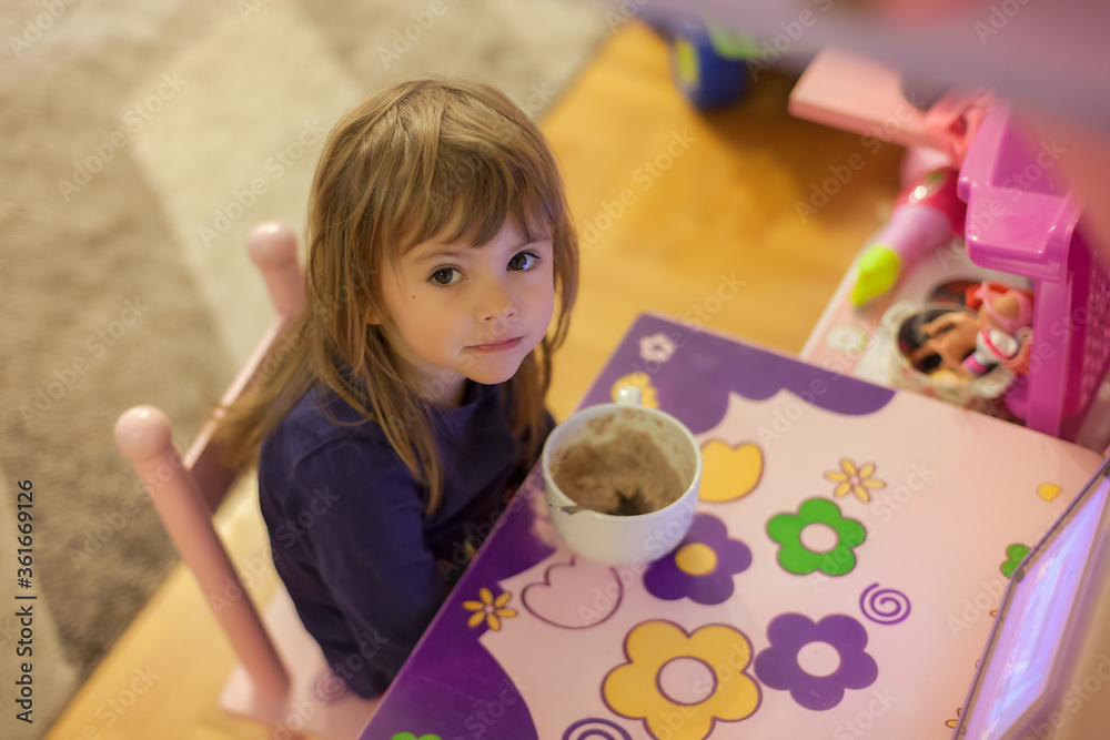 little girl eats alone