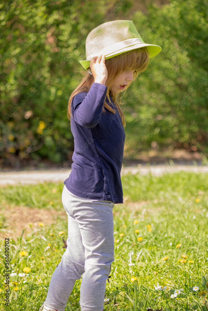 a girl with a green hat