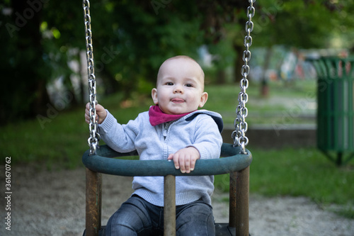 Happy Baby Playing With the Swing