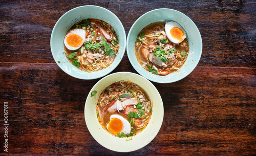Tom Yam Thai with soft-boiled eggs comes in a small bowl.That has egg noodles, vermicelli and thin rice noodles...