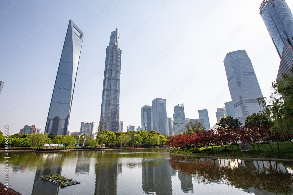 Central Park in Lujiazui, with a pond and a lawn in the middle of modern skyscrapers, in Shanghai, China.