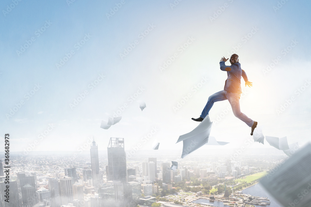 Businessman jumping high in the air