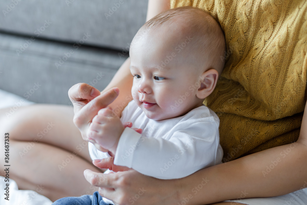 Happy mom and baby playing together on the bed at home . family love concept. Happy mom and baby playing together on the bed at home . family love concept.