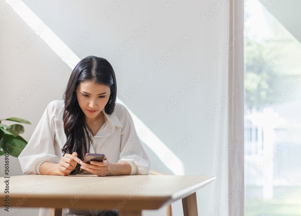 Young Asian woman using smartphone for texting message to lover Young Asian woman using smartphone for texting message to lover