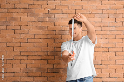 Young man with measuring ta...