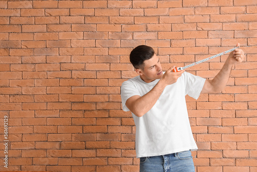 Young man with measuring ta...