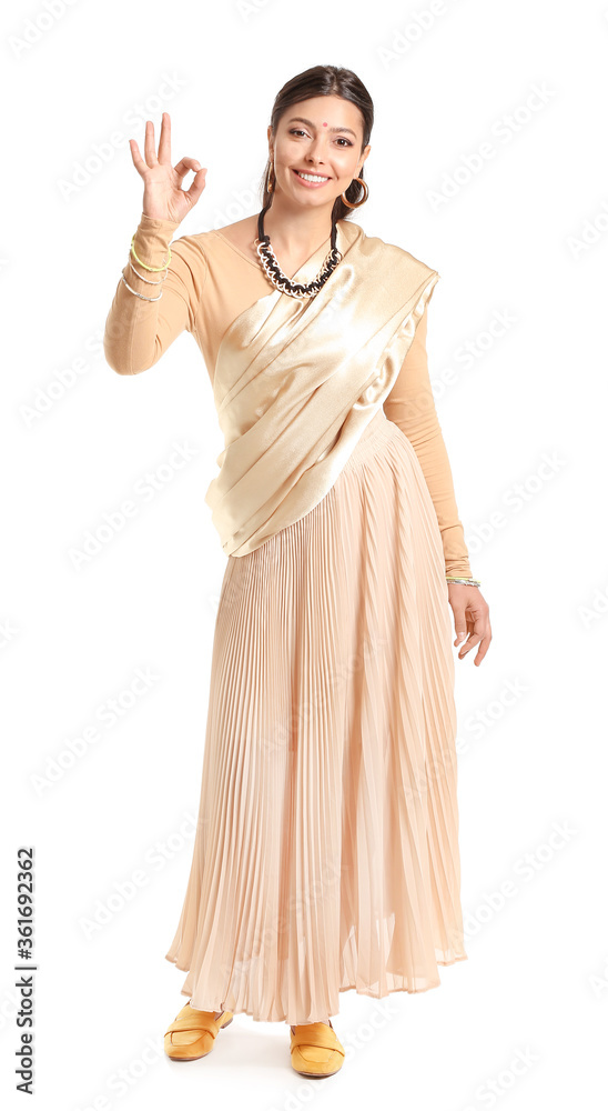 Beautiful young Indian woman showing OK on white background