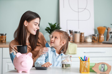Little girl and her mother with savings for education at home