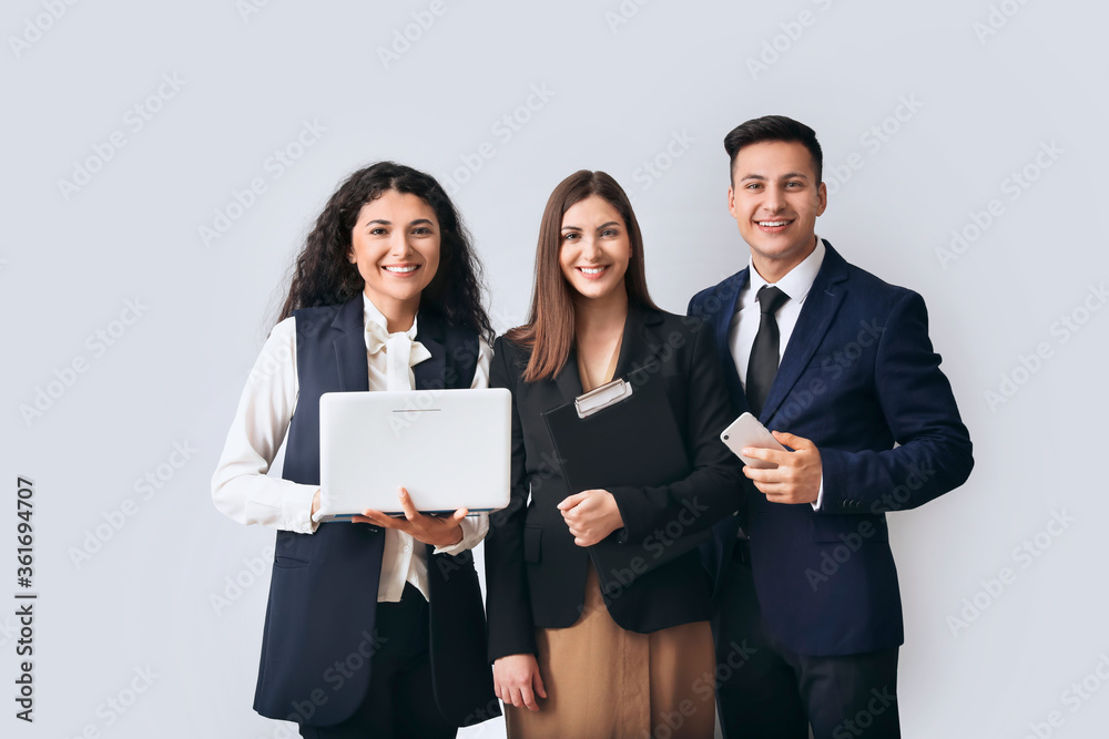 Young business people on light background Young business people on light background