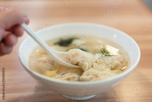 Wonton soup, Chinese traditional food with boiled meat filled wonton and seaweed soup.