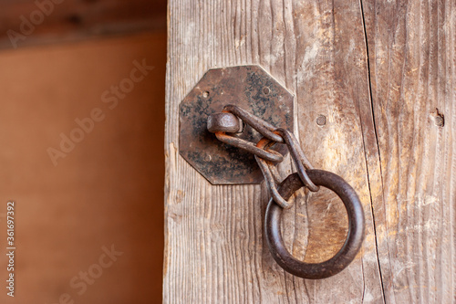rusty chain on wooden door