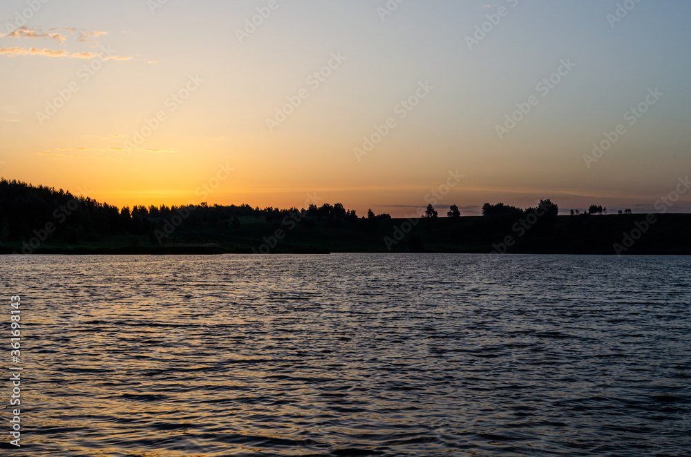 Naklejka premium Sunrise over the lake. Summer dawn