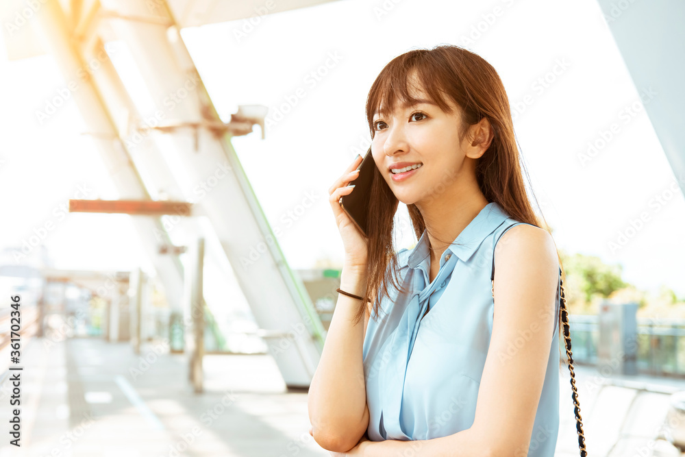 young business woman talking on the phone in train station young business woman talking on the phone in train station