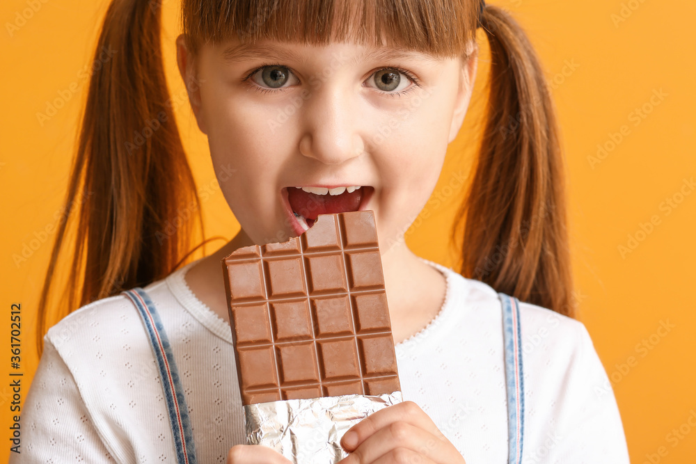 Cute funny girl with chocolate on color background Cute funny girl with chocolate on color background