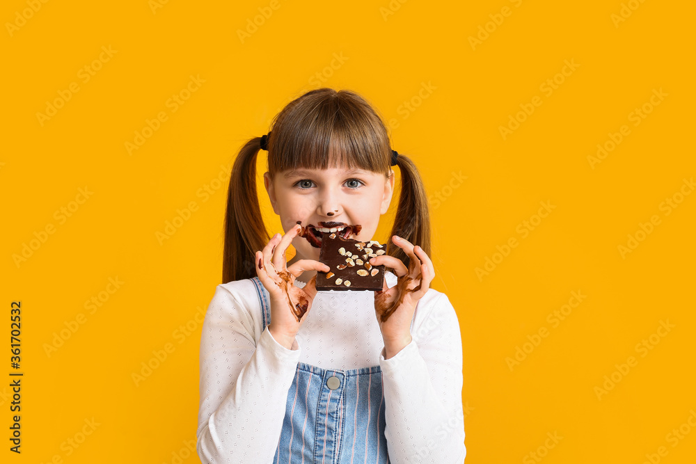 Cute funny girl with chocolate on color background Cute funny girl with chocolate on color background