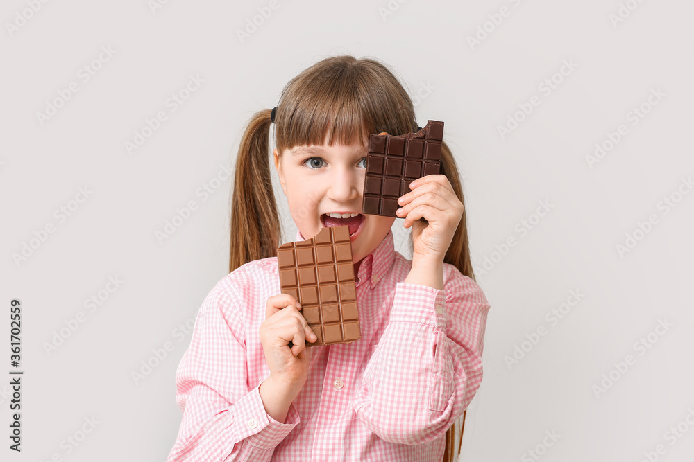Cute funny girl with chocolate on light background Cute funny girl with chocolate on light background