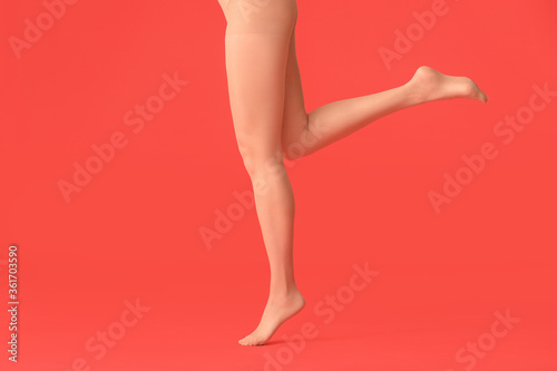 Beautiful young woman in tights on color background