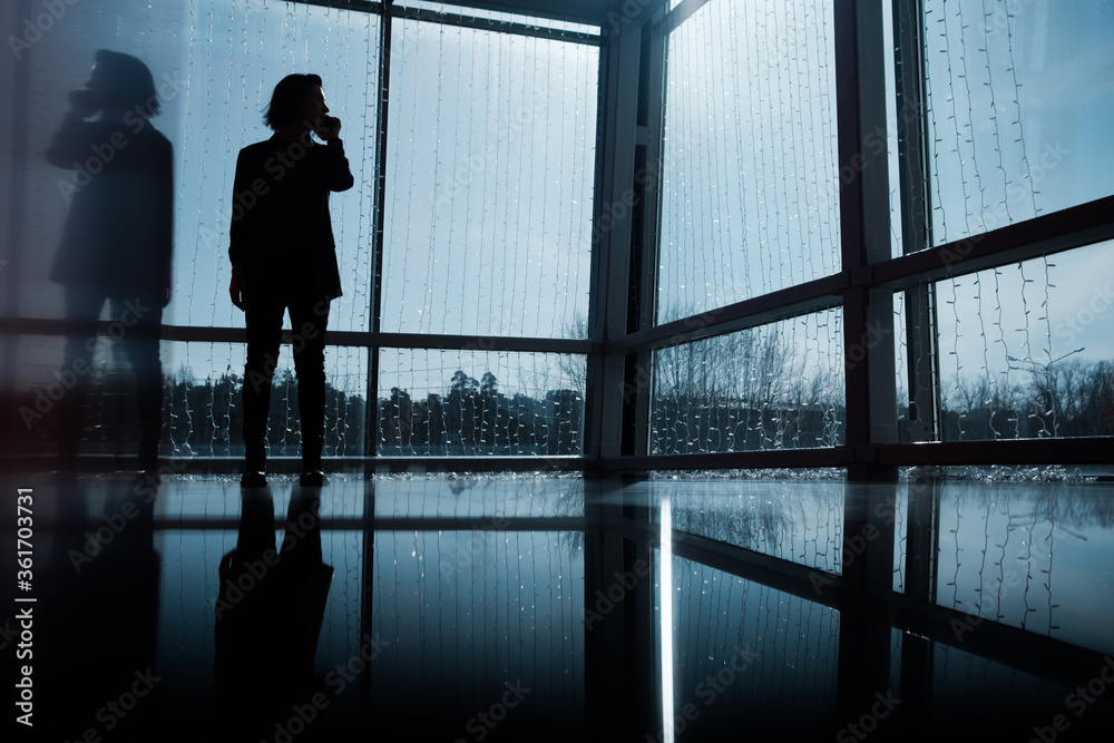 Photo business woman talking smartphone and holding documents in hands. Open space loft office. Panoramic windows background. Horizontal mockup. Film effect.