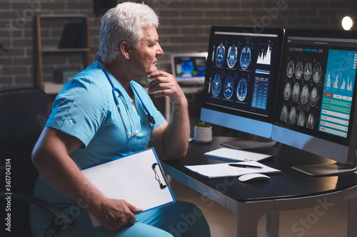 Senior neurologist with MRI...