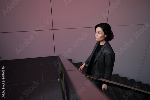 Business Women Style. Woman Going To Work Walking Downstairs. Portrait Of Beautiful Smiling Female In Stylish Office Clothes Going Down Stairs..