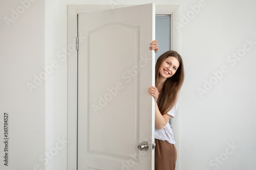 Curious woman looking out t...