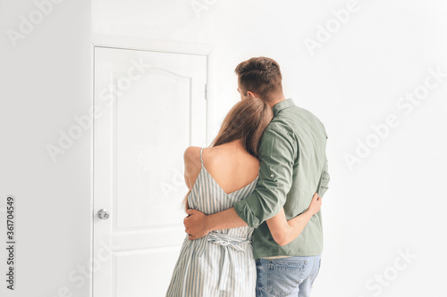 Happy couple in front of do...
