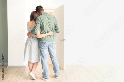 Happy couple in front of do...
