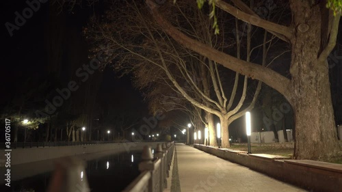 Empty city river embankment lit by lanterns at night in autumn. Salgir River Embankment in Simferopol. photo