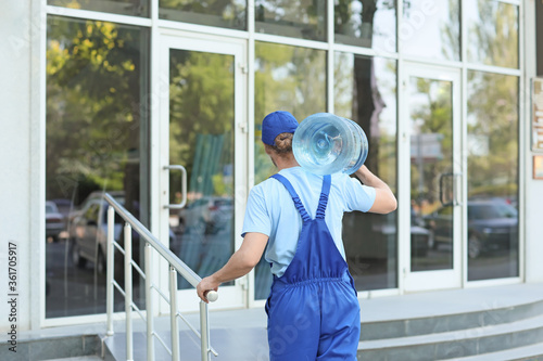 Delivery man with bottle of...