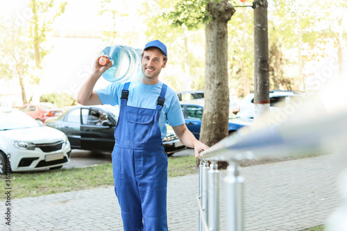 Delivery man with bottle of...