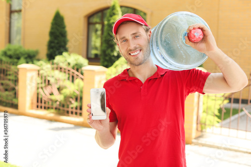 Delivery man with bottle of...