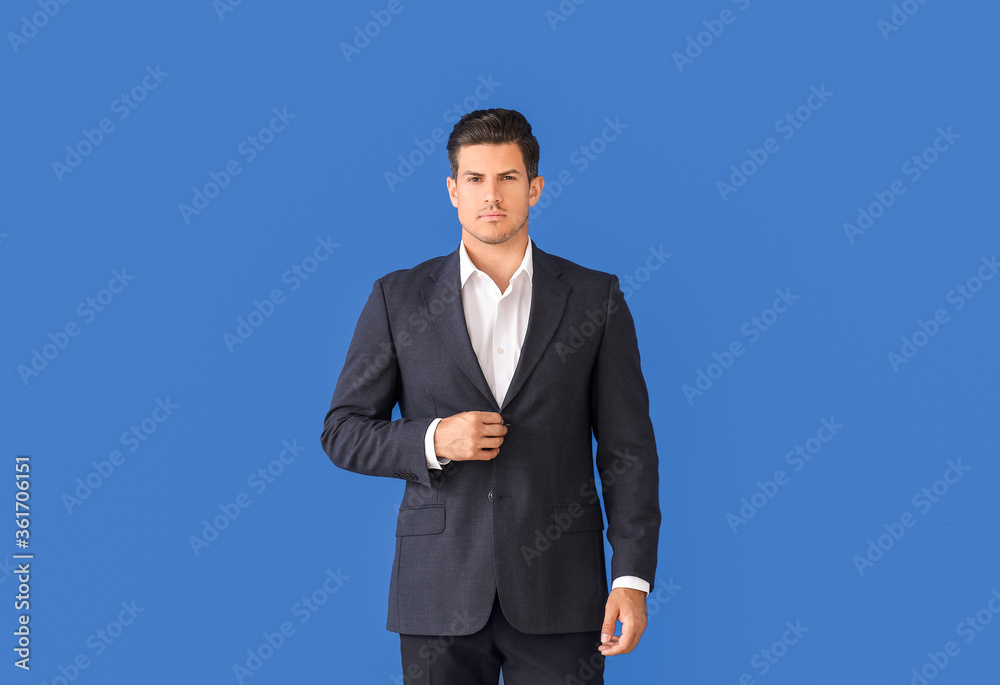 Young businessman in stylish suit on color background Young businessman in stylish suit on color background