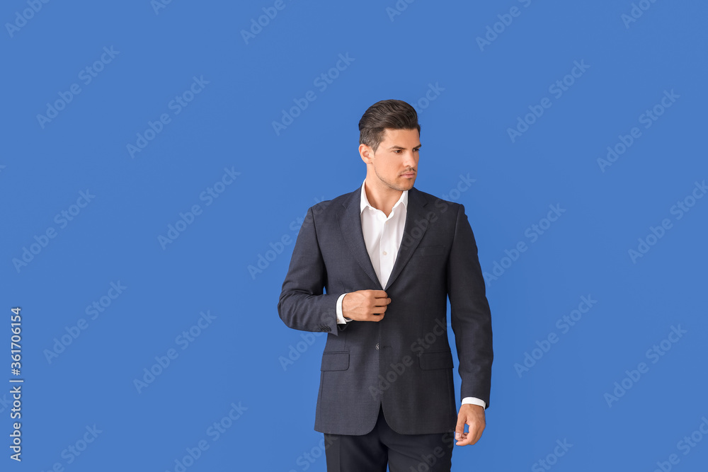 Young businessman in stylish suit on color background Young businessman in stylish suit on color background