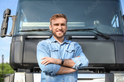 Male driver near big truck ...