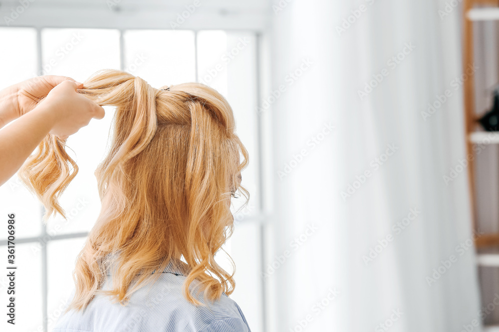Fototapeta premium Hairdresser working with client in beauty salon
