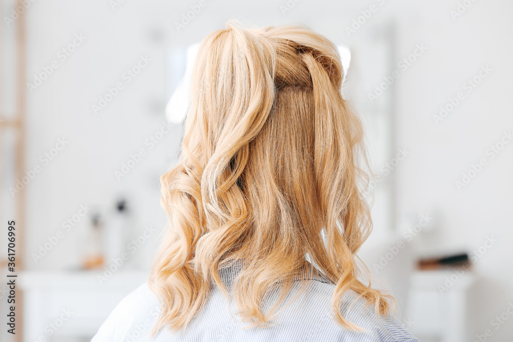 Naklejka premium Young woman with stylish hairdo in beauty salon
