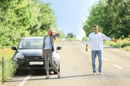 Young couple near broken car on road © Pixel-Shot