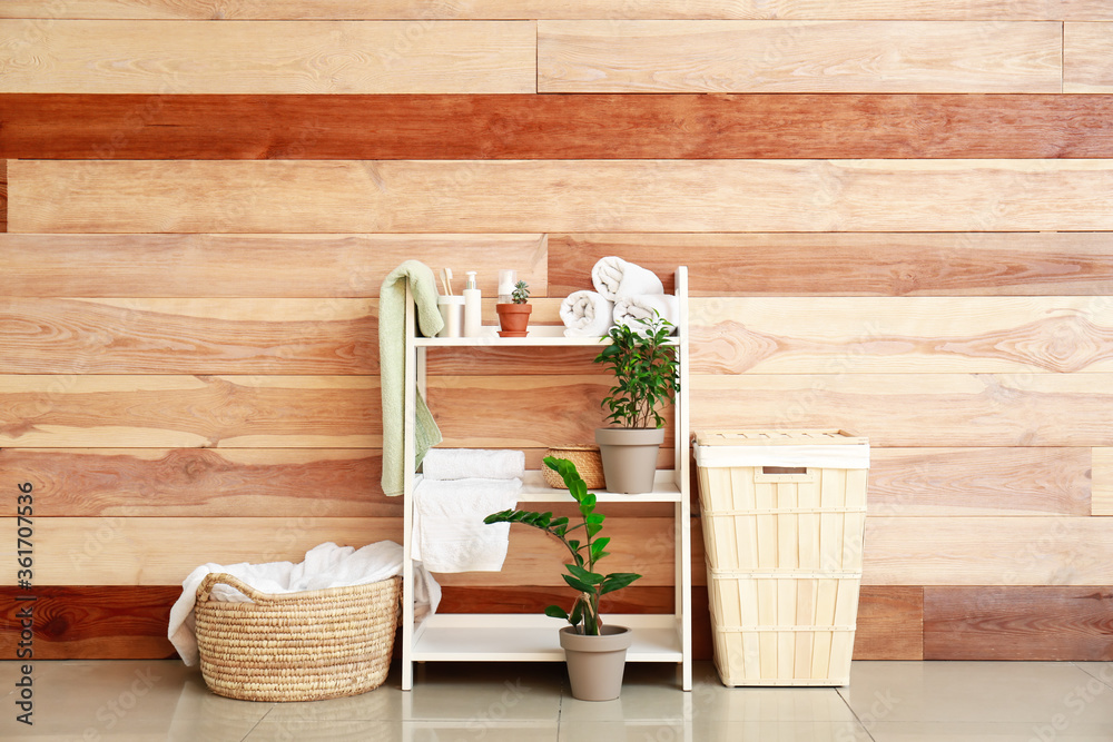 Rack and baskets with towels and supplies in bathroom Rack and baskets with towels and supplies in bathroom