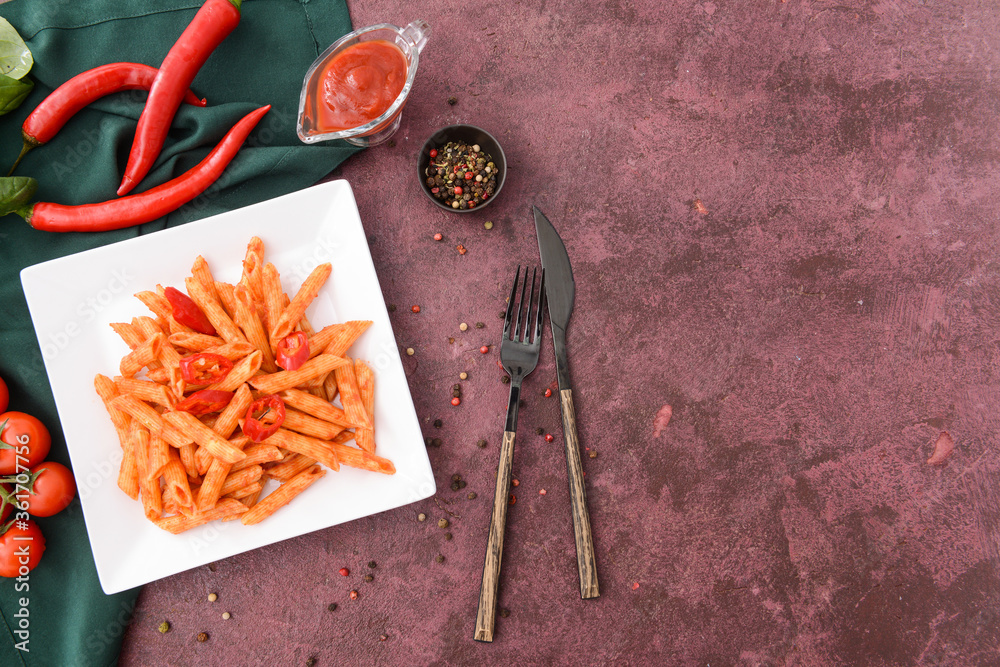 Plate with tasty pasta and tomato sauce on color background Plate with tasty pasta and tomato sauce on color background