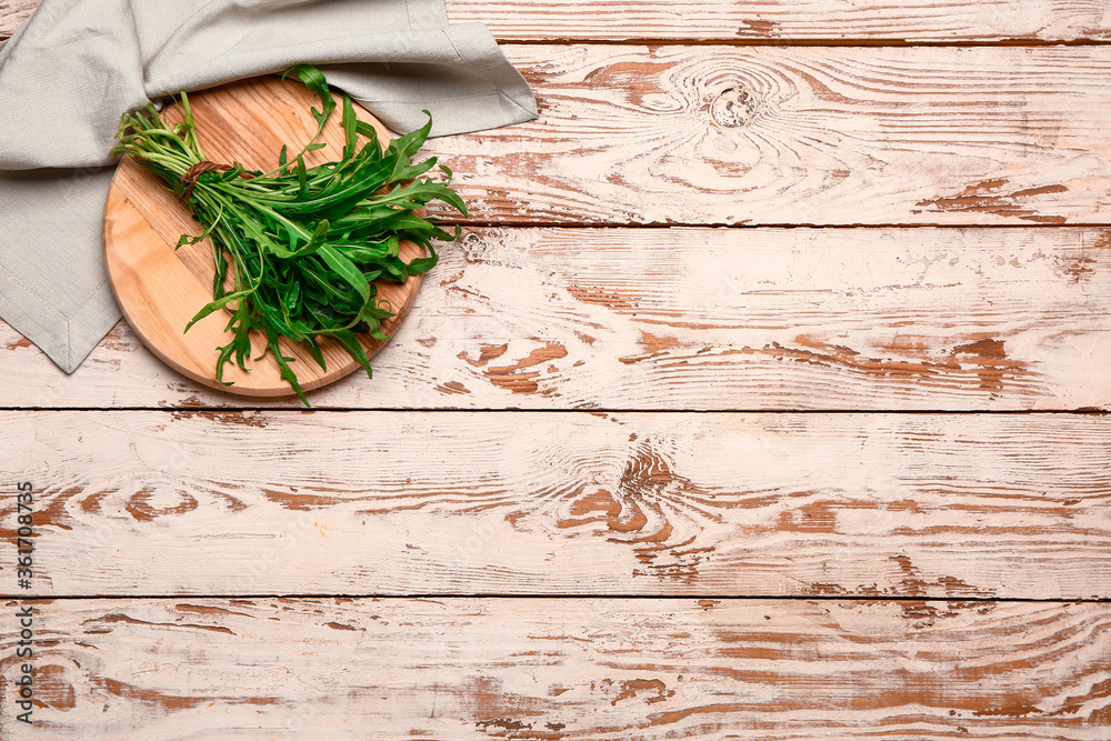 Bunch of fresh arugula on wooden background Bunch of fresh arugula on wooden background