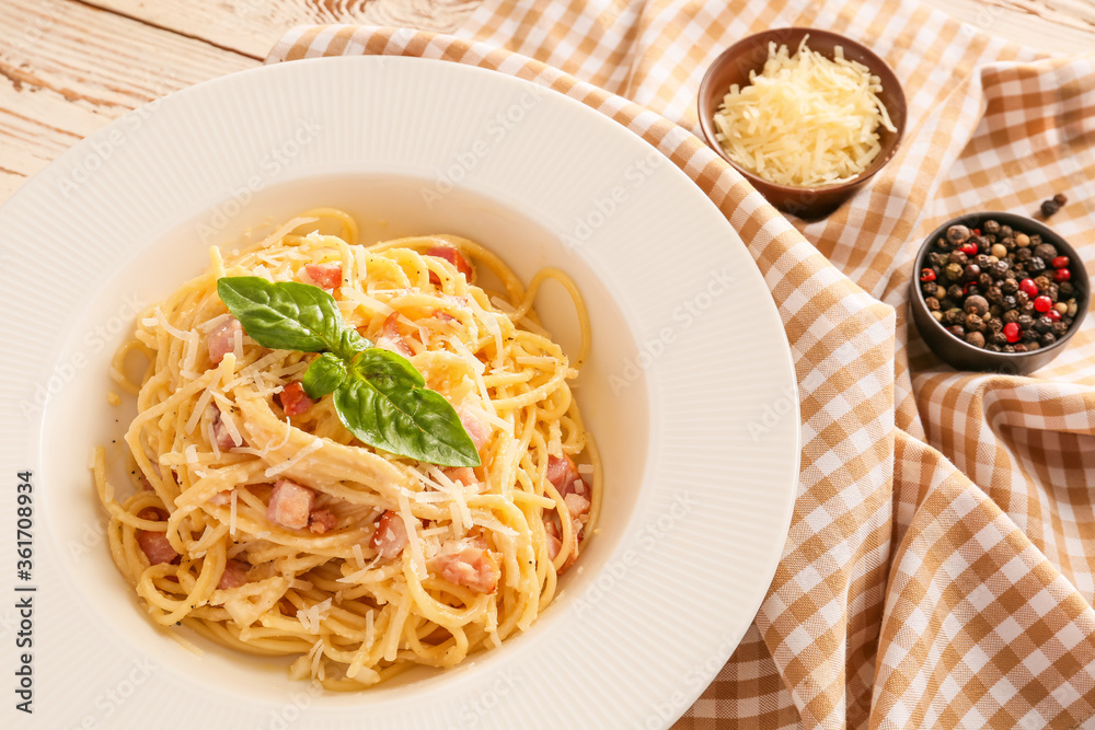 Plate with tasty pasta carbonara on table