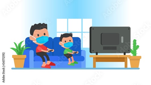 Dad and son playing game at home on self-quarantine. Family quarantined coronavirus in protective masks.
