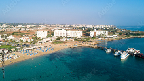 Aerial bird's eye view of Sunrise beach Fig tree, Protaras, Paralimni, Famagusta, Cyprus.The famous tourist attraction family bay with golden sand, boats, sunbeds, restaurants, water sports from above © f8grapher