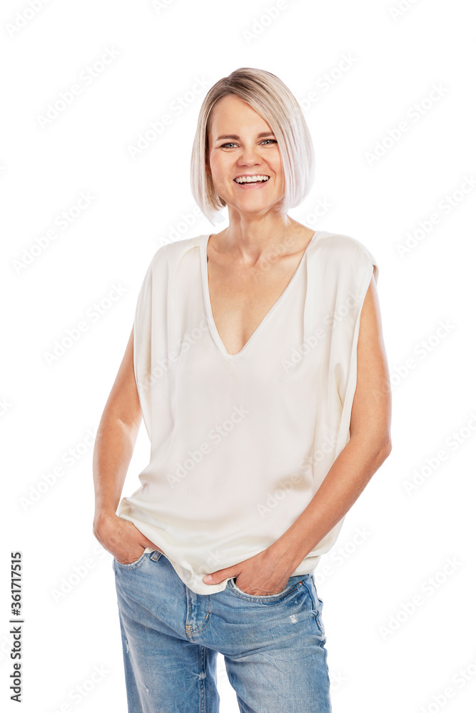 Obraz premium Laughing blonde in jeans and a white tank top. Emotion and joy. Isolated on a white background. Vertical.