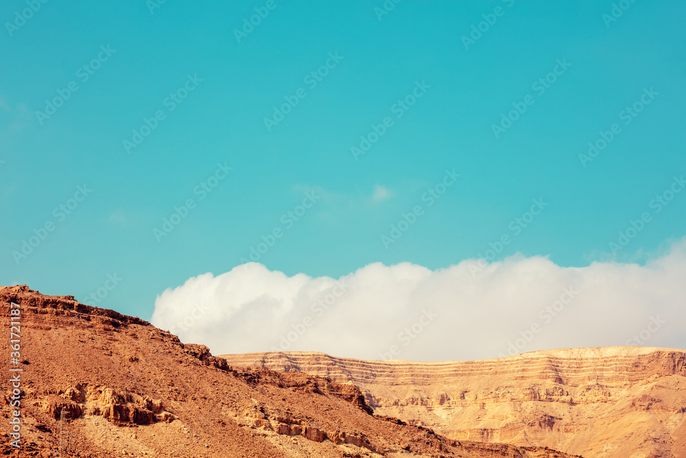Abstract desert landscape. Top of sandstone against blue sky with cloud Abstract desert landscape. Top of sandstone against blue sky with cloud