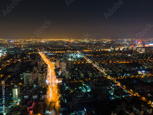 Aerial view of Shanghai cityscape   night-scape. Futuristic modern city view. Downtown residential buildings and avenue highways in the night. Modern futuristic city view with neon and traffic lights