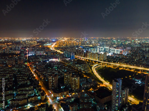 Aerial view of Shanghai cityscape & night-scape. Futuristic modern city view. Downtown residential buildings and avenue highways in the night. Modern futuristic city view with neon and traffic lights